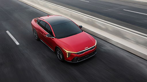 Red 2025 Kia K4 compact sedan with sleek design and modern styling
